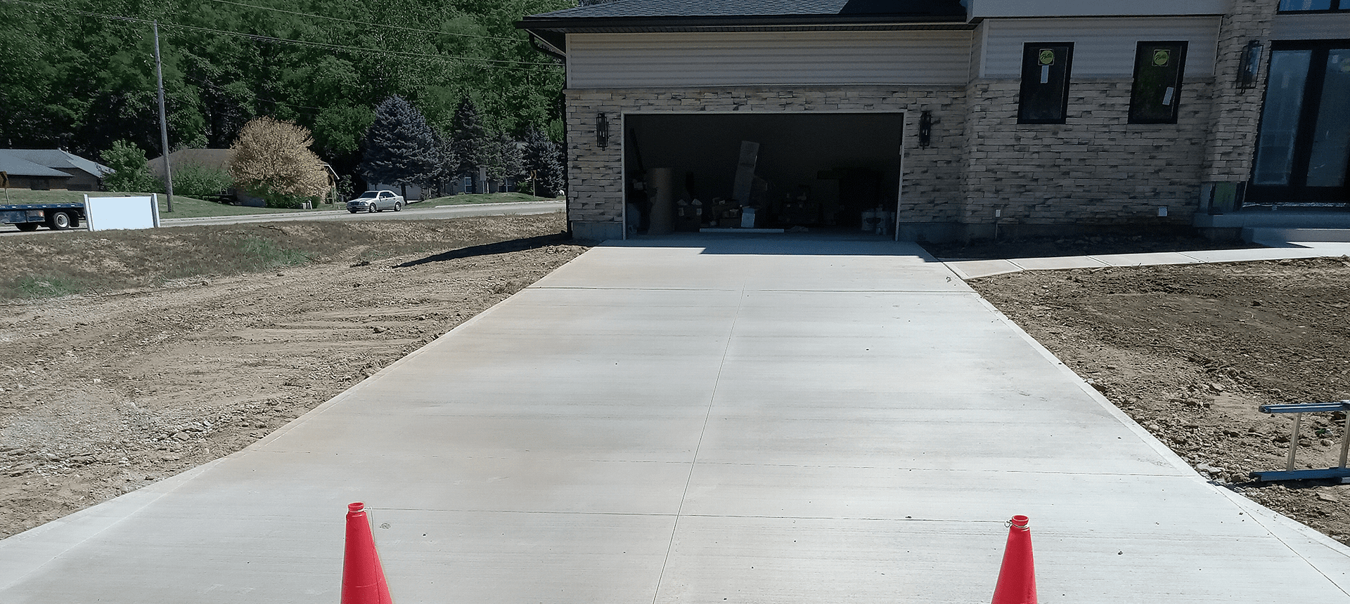 Freshly paved driveway leading to garage